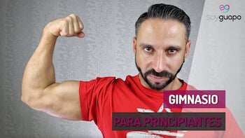 Rubén Lara flexionando bíceps con texto superpuesto: "Consejos Para Empezar en el Gimnasio". Fondo con textura gris.