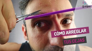 Rubén Lara usa unas tijeras pequeñas y un peine para recortar el vello de la ceja. El texto superpuesto dice "Rutina fácil para arreglar las cejas".